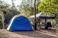 Tent setup with gazebo canopy shelter at the campsite surrounding by nature on the river bank Royalty Free Stock Photo