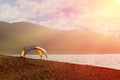 Tent shelter on lake shore at sunset - tranquil scene conveying calmness and freedom. Royalty Free Stock Photo