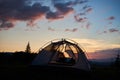 Magical landscape camping at sunset on background of fir trees and mighty mountains