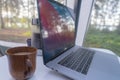 And the tent on the table is a laptop, a coffee pot, a cup of coffee. Good morning concept. Summer vacation in nature Royalty Free Stock Photo