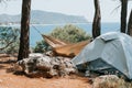 tent vacationing relaxing traveler on the seashore. man napping in a hammock and a pet dog. camping on a trip and hiking on the oc Royalty Free Stock Photo