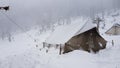 Tent which is covered with heavy snowfall in a campsite.