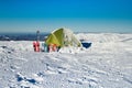 Tent winter mountains.Tent stands in the mountains in the snow. Snowshoes are beside the tent.