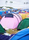 Tents, campsite and music festival on outdoor field or mess pollution, garbage from party crowd. Shelter, group and