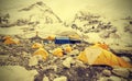 Tents in Everest Base Camp in cloudy day, vintage effect.