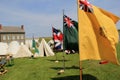 Tents and flags set up in front of stone buildings during reenactments, Fort Ontario, New York, 2016
