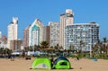 Tents Pitched 0n Beach Against City Skyline