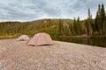 Tents at river in remote Yukon taiga wilderness