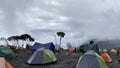 Tents are in the Shira Cave Camp. Foggy mountain landscape. Climbing Kilimanjaro, Africa