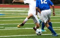 Two boys fight for soccdr ball during game