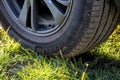 Teplyk, Ukraine - August 13 2023: Car wheel on the green grass
