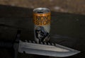 Teplyk, Ukraine - 06 November 2023: Can Non Stop Stalker energy drink and black knife