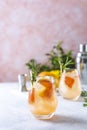 Tequila cocktail or cold lemonade with grapefruit juice, tinted with the aroma of a fresh sprig of rosemary Royalty Free Stock Photo