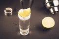 Tequila shot with lime fruit and shaker/Tequila shot with lime fruit and shaker on a dark background. Selective focus Royalty Free Stock Photo