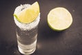Tequila shot with lime fruit/Tequila shot with lime fruit on a dark background. Selective focus Royalty Free Stock Photo