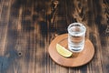 Tequila shot and lime slice on wooden table/Tequila shot and lime slice on wooden table with copy copyspace. Top view Royalty Free Stock Photo