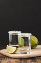 Tequila shot with lime slices and salt on wooden table/Tequila shots and lime slice on wooden table.With copy space on black Royalty Free Stock Photo