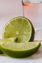 Tequila shot with a slice of lime on the glass orange background Royalty Free Stock Photo