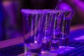 Tequila shots on the bar table, blue light and nightlife situation in Royalty Free Stock Photo