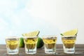 Tequila shots with salt and lime slices on wood table Royalty Free Stock Photo