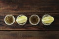 Tequila shots with salt and lime slices on wood table Royalty Free Stock Photo