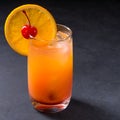 Tequila sunrise cocktail on dark stone background with copy space. Royalty Free Stock Photo