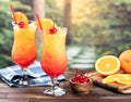 Tequila sunrise cocktail with orange slice and cherry