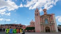 Tequisquiapan, Mexico, 22.03.2018: view to Santa Maria Cathedral in downtown and sign TEQUIS next to it. Timelapse shot.