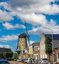 Street in rural dutch village with old traditional windmill