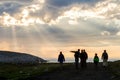 Teriberka, Russia - July 30, 2017: Group of tourists walking on the shore of the Arctic Ocean at sunset