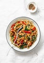 Teriyaki chicken, bell peppers, onions, spinach and rice noodles stir fry on white background, top view. Asian style