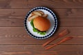 teriyaki hamburger with boiled egg on plate isolated on wooden table Royalty Free Stock Photo