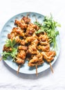 Teriyaki marinated duck skewers on a light background, top view. Delicious snack, tapas, appetizers