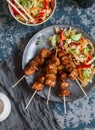 Teriyaki pork skewers and marinated vegetable salad.Asian style lunch