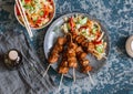 Teriyaki pork skewers and marinated vegetable salad.Asian style lunch