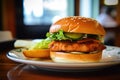 Teriyaki salmon burger, with a grilled salmon fillet, teriyaki sauce, lettuce, cucumber, and wasabi mayo on a brioche Royalty Free Stock Photo