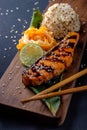 Teriyaki salmon with rice on a wooden platter Royalty Free Stock Photo