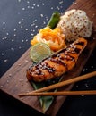 Teriyaki salmon with rice on a wooden platter Royalty Free Stock Photo