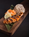 Teriyaki salmon with rice on a wooden platter. Top Royalty Free Stock Photo