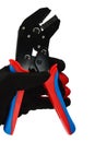 Terminal crimping press pliers with half closed jaws, held in left hand in thin black nylon/polyester/spandex glove