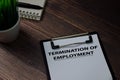 Termination of Employment write on paperwork isolated on wooden table Royalty Free Stock Photo