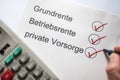 Terms basic pension, company pension and private provision in german language as a ticked list Royalty Free Stock Photo