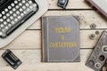 Terms and Conditions on old book cover at office desk with vintage items Royalty Free Stock Photo