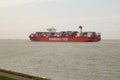 A big red container ship closeup is navigating through river scheldt in summer Royalty Free Stock Photo