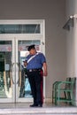 carabiniere standing in front of the court with telephone in hand