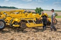 TERNOPIL REGION, UKRAINE - August 10, 2021: man inspect tractor cultivator on demonstration of agricultural machinery, exhibition