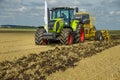 TERNOPIL REGION, UKRAINE - August 10, 2021: tractor Claas 950 Axion with disc harrow Bednar, soil cultivation system in operation