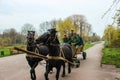 Ternopil, Ukraine - April 08, 2014: City park workers move on horse-drawn carts from one end of the park to the other