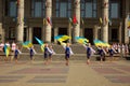 TERNOPIL, UKRAINE - AUGUST 21, 2021: Girls in traditional Ukrainian costumes wave blue and yellow flags. Rehearsal