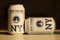 TERNOPIL, UKRAINE - JULY 18, 2022 Two cans of New Yorker fine lager beer with original logo and design on brown retro background